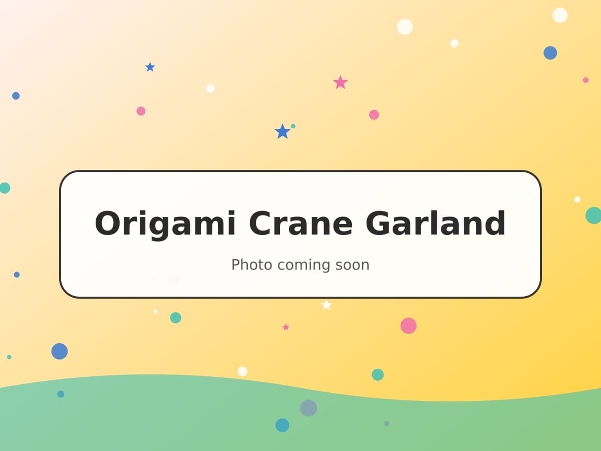 A garland of rainbow-coloured origami cranes hanging in a sunny window